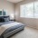 a bedroom with a bed and a fan