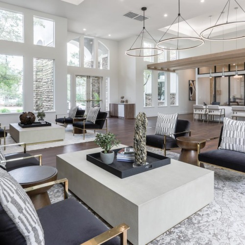 Settle into comfort at Legacy at Highlands Ranch a large living room with a large chandelier and a large white table