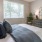 a bedroom with a bed and a fan
