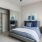 a bedroom with a bed and a fan