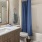 a bathroom with a blue shower curtain